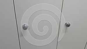 Perspective view of lockers or cupboards in a row with white doors