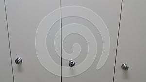 Perspective view of lockers or cupboards in a row with white doors