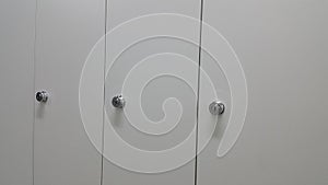 Perspective view of lockers or cupboards in a row with white doors