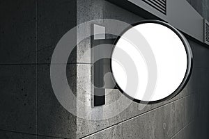 Perspective view on night grey concrete wall background with blank lighting round white signboard with place for your brand name,