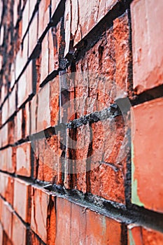 Perspective view of old red destructed brick wall