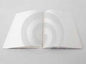 Perspective view of open and blank notepad isolated on white background. Aerial view of notebook to write made with sustainable