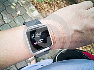 Perspective view of person checking tracker watch during exercise