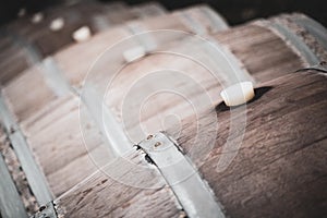 Row of vintage wine barrique barrels in a winery cellar