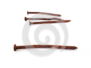 Perspective view of Set of rusty nails on white background. Close up of Bunch of old wry rusty nails shot from above on white.