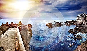 Perspective view of a stone pier in the sea. Seascape background in the ocean. Travel and vacation concept. Tenerife,