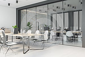 Perspective view on stylish wooden meeting table surrounded by white chairs in spacious conference room with glass partitions, photo