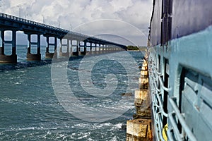 Perspective view to a road bridge from a indian railway train on the Pamban Bridge