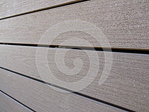 Perspective view of a wooden panel with horizontal boards and a natural finish. Thick veneers pattern. Construction textures and