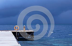 Perspective view of a wooden pier on the tropical seashore  sea with turquoise water