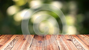Perspective wood and bokeh light background. product display template. Wood table top on blur moving natural green leaf