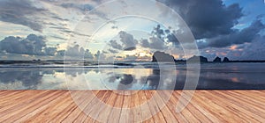 Perspective of wood terrace against beautiful seascape at sunset