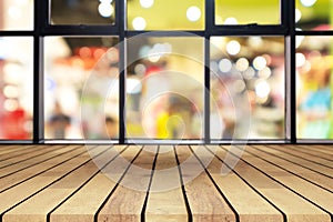 Perspective wooden board empty table on top over blurred coffee shop background, can be used mock up for display of product or