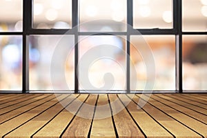 Perspective wooden board empty table on top over blurred coffee shop background, can be used mock up for display of product or