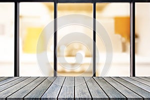 Perspective wooden board empty table on top over blurred coffee shop background, can be used mock up for display of product or