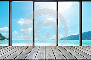 Perspective wooden board empty table on top over blurred sea view background, can be used mock up for display of product or design