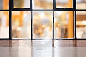 Perspective wooden floor empty table on top over blurred coffee shop background, can be used mock up for display of product or