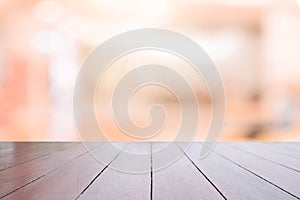 Perspective wooden table on top over blur background, can be used mock up for montage products display or design layout