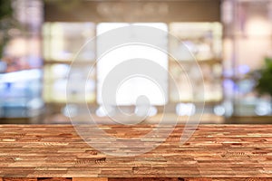 Perspective wooden table on top over blur coffee shop background