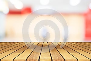 Perspective wooden table on top over blur coffee shop background