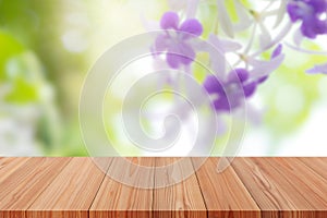 Perspective wooden table on top over blur natural background, can be used mock up for montage products display or design layout