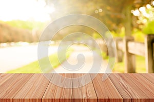 Perspective wooden table on top over blur natural background, can be used mock up for montage products display or design layout