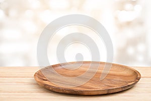 Perspective wooden table and wooden tray on top over blur bokeh light background, can be used mock up for montage products display
