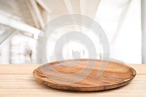 Perspective wooden table and wooden tray on top over blur mall background, can be used mock up for montage products display or