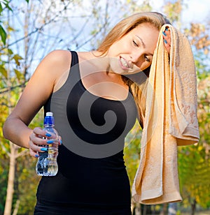 Perspiring woman athlete wiping her