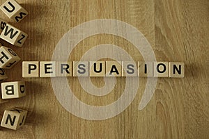 Persuasion word from wooden blocks photo