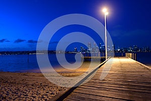 Perth central business district skyline as view from the Swan river bank pier at dusk