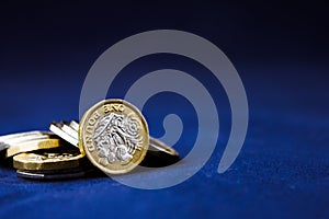 Perth, Scotland - 5 December 2019: One pound coins stacked on a dark background - UK economy