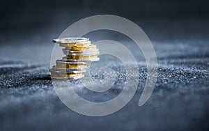 Perth, Scotland - 5 December 2019: One pound coins stacked on a dark background - UK economy