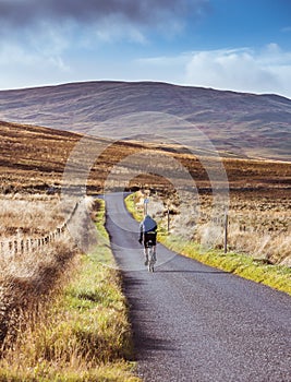 Perthshire, Scotland - 29 October 2019: cyclist cycling on a rural road around Scotland