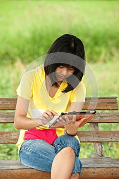 Pertty Asian young girl on tablet.
