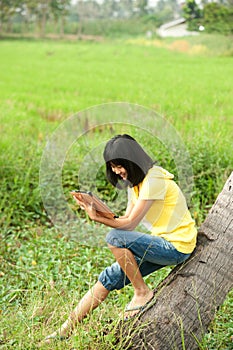 Pertty Asian young girl on tablet .