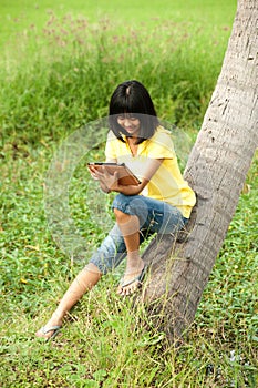 Pertty Asian young girl on tablet .