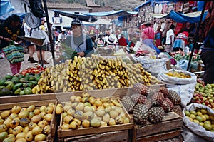 PERU Peruvians dressed in traditional clothing in Cusco. Man selling fruit and vegetables in Cusco, Peru,