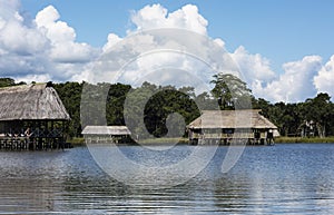 Peru Tingo Maria picturesque lagoon of miracles in the Amazon jungle with wooden houses thatched roofs on the palafitos river with