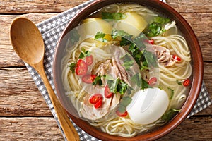 Peruvian Caldo de Gallina Chicken Soup closeup in the plate. horizontal top view