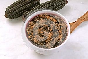 Peruvian dessert called mazamorra morada the main ingredient purple corn visible in the back