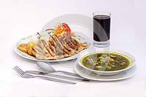 Peruvian Dish:Chicken soup of coriander,aguadito de pollo)+chicha morada (purple corn juice) and chicken grilled.