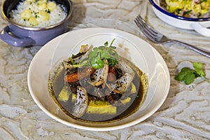 Peruvian dish Lomo saltado - Pieces of sirloin sauteed in the wok, accompanied by fried potatoes and white rice with corn