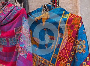 Peruvian Female colorful dress poncho with shape llama in market Machu Picchu one of the New Seven Wonder of The World, Cusco
