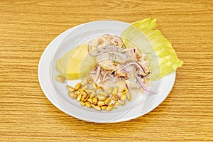 Peruvian fish ceviche dish with court garnish and cooked potato