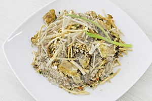 Peruvian food, "arroz chaufa" fried rice with wantan over white background.