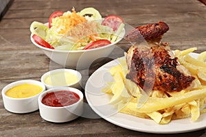 Peruvian food called Pollo a la brasa with salad and french fries