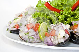 Peruvian food: Choros a la chalaca, mussels seasoned with onion, tomato and lemon photo