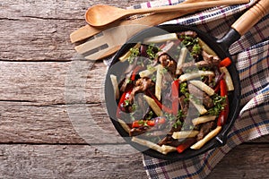 Peruvian Food: Lomo saltado in a frying pan. horizontal top view