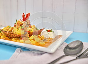 PERUVIAN FOOD: Picante de Mariscos with rice, sea food. Selective focus